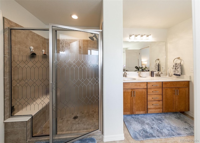 4330 Prairie Agate Dr, Colorado Springs, CO 80938 - full bath with double vanity, a shower stall, and recessed lighting