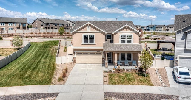 4330 Prairie Agate Dr, Colorado Springs, CO 80938 - view of front facade with covered porch, stucco siding, concrete driveway, a residential view, and a garage