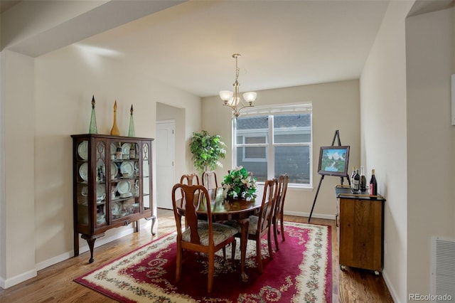 2033 E 167th Way, Thornton, CO 80602 - dining area with a chandelier, wood finished floors, and baseboards