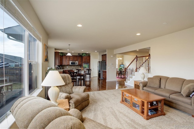 2033 E 167th Way, Thornton, CO 80602 - living room featuring stairway, recessed lighting, and wood finished floors