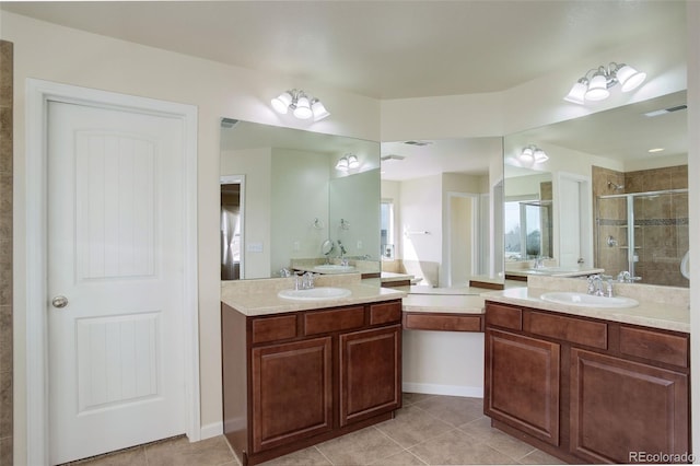 2033 E 167th Way, Thornton, CO 80602 - full bath with a stall shower, tile patterned floors, and two vanities