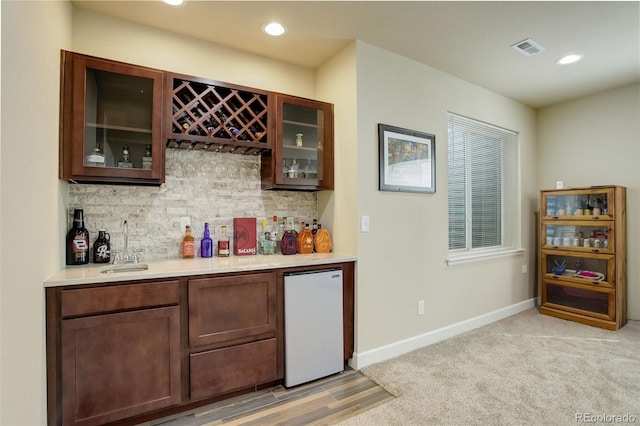 2033 E 167th Way, Thornton, CO 80602 - indoor dry bar with fridge, backsplash, baseboards, recessed lighting, and light colored carpet