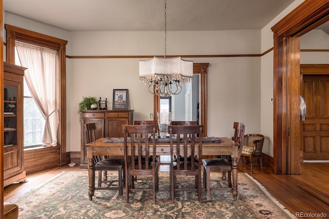 131 N Sherman St, Denver, CO 80203 - dining room featuring a chandelier, wood finished floors, and baseboards