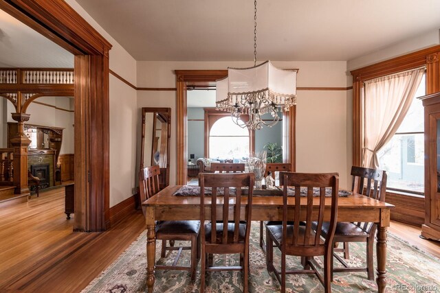 131 N Sherman St, Denver, CO 80203 - dining room with a chandelier, light wood-type flooring, healthy amount of natural light, and baseboards