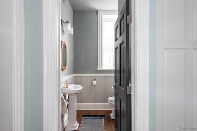 131 N Sherman St, Denver, CO 80203 - bathroom featuring wood finished floors, toilet, and wainscoting