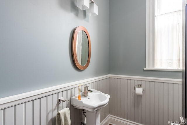 131 N Sherman St, Denver, CO 80203 - half bathroom featuring a wainscoted wall and a sink