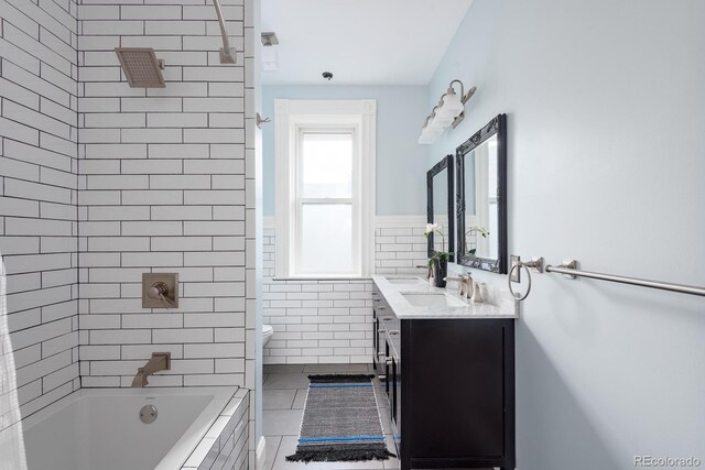 131 N Sherman St, Denver, CO 80203 - bathroom featuring tile walls, vanity, toilet, tile patterned flooring, and a wainscoted wall