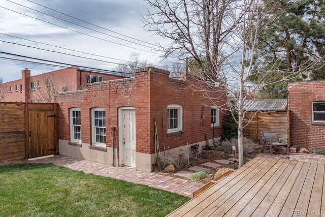 131 N Sherman St, Denver, CO 80203 - rear view of property with fence, a gate, a deck, and brick siding