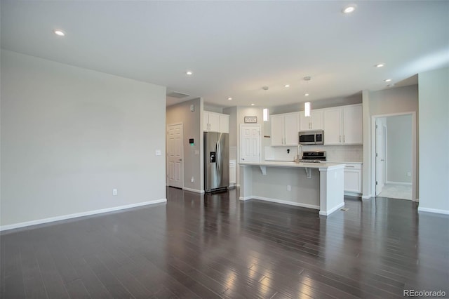 unfurnished living room featuring dark hardwood / wood-style floors