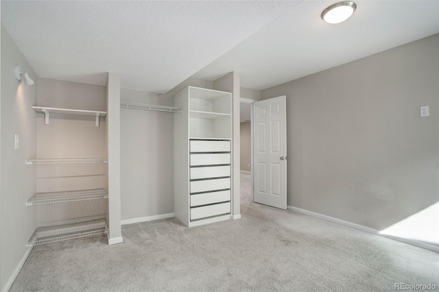 walk in closet with light colored carpet