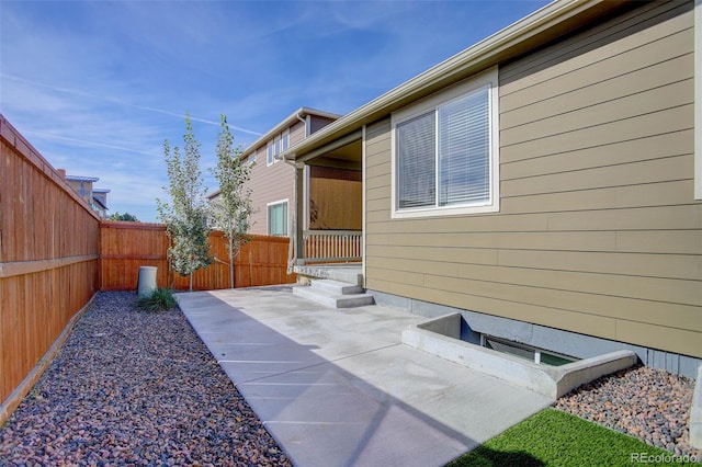 view of property exterior with a patio and a fenced backyard