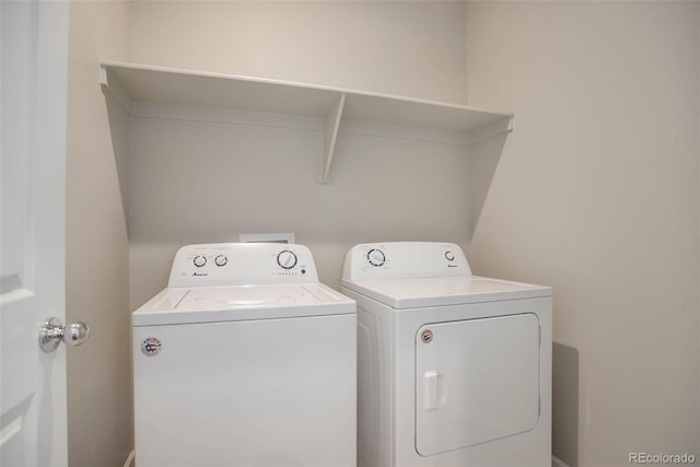 laundry room with washing machine and clothes dryer