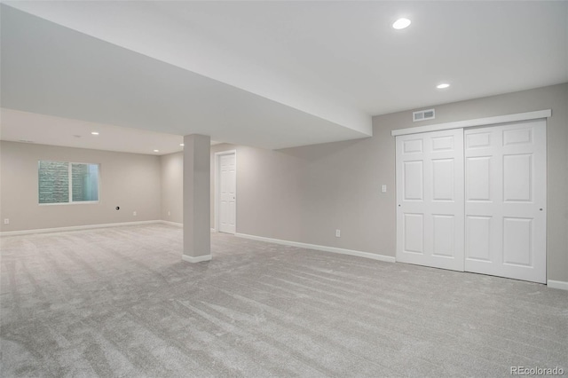 basement featuring light carpet