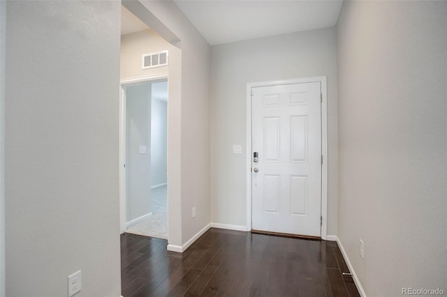 entryway with visible vents, baseboards, and dark wood finished floors