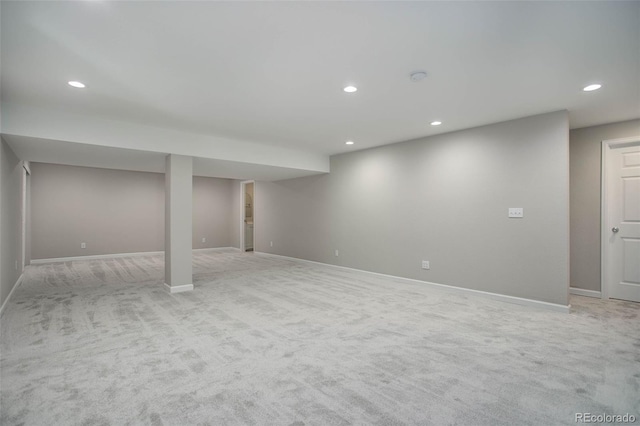 finished below grade area with recessed lighting, baseboards, and light colored carpet