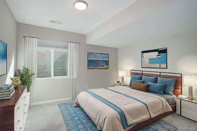 bedroom with visible vents, light colored carpet, and baseboards