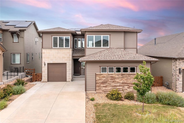 18815 W 93rd Ave, Arvada, CO 80007 - prairie-style home with concrete driveway, stone siding, roof with shingles, and a garage