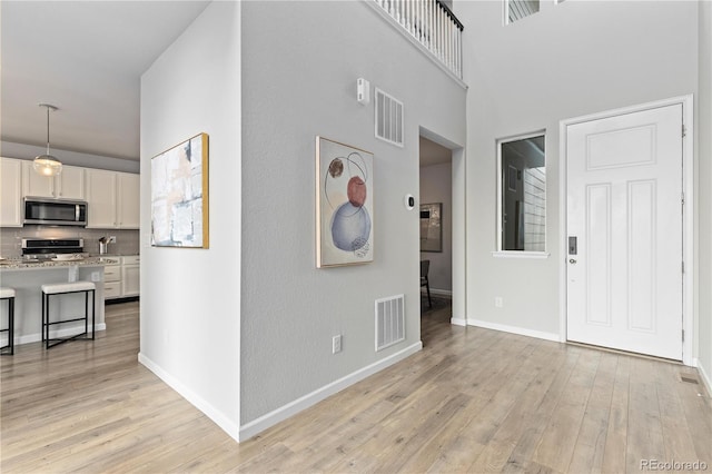 18815 W 93rd Ave, Arvada, CO 80007 - entryway with light wood-style floors and a high ceiling