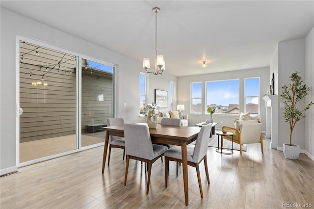 18815 W 93rd Ave, Arvada, CO 80007 - dining area with a chandelier and light wood-style floors