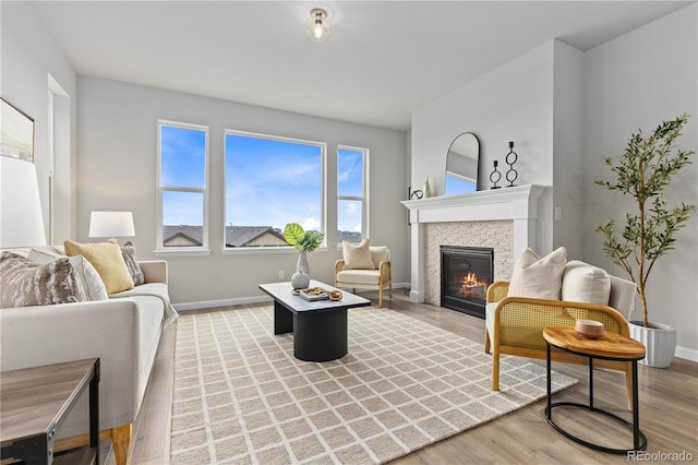 18815 W 93rd Ave, Arvada, CO 80007 - living room featuring a glass covered fireplace and light wood-style flooring