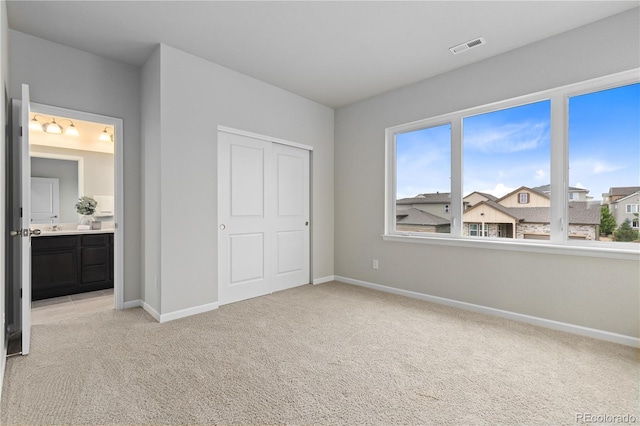 18815 W 93rd Ave, Arvada, CO 80007 - unfurnished bedroom with light colored carpet and ensuite bathroom