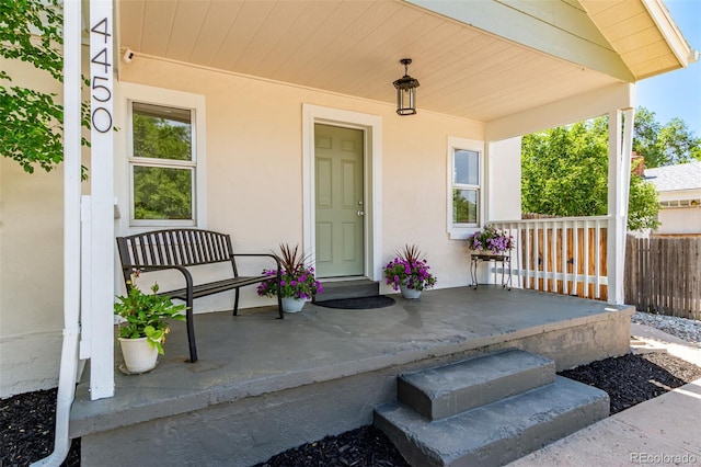 4450 S Fox St, Englewood, CO 80110 - property entrance featuring covered porch and stucco siding