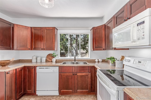 4450 S Fox St, Englewood, CO 80110 - kitchen featuring white appliances, light countertops, and dark brown cabinets