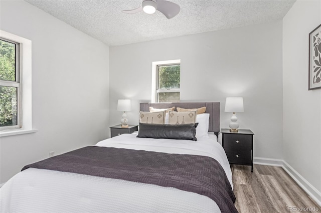 4450 S Fox St, Englewood, CO 80110 - bedroom featuring wood finished floors, a textured ceiling, and a ceiling fan