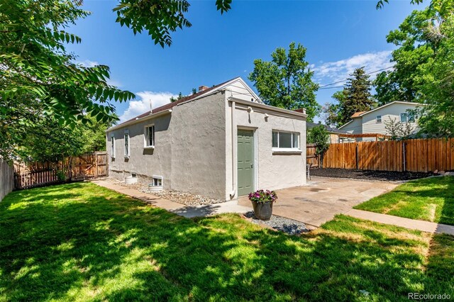 4450 S Fox St, Englewood, CO 80110 - rear view of property with a fenced backyard, stucco siding, and a patio