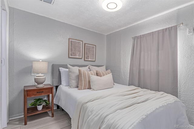 4450 S Fox St, Englewood, CO 80110 - bedroom with a textured wall, wood finished floors, and a textured ceiling