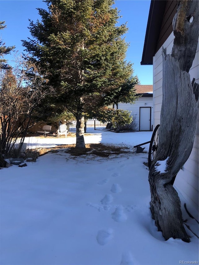 view of yard layered in snow