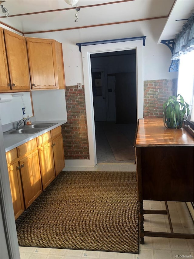 kitchen with brick wall and sink