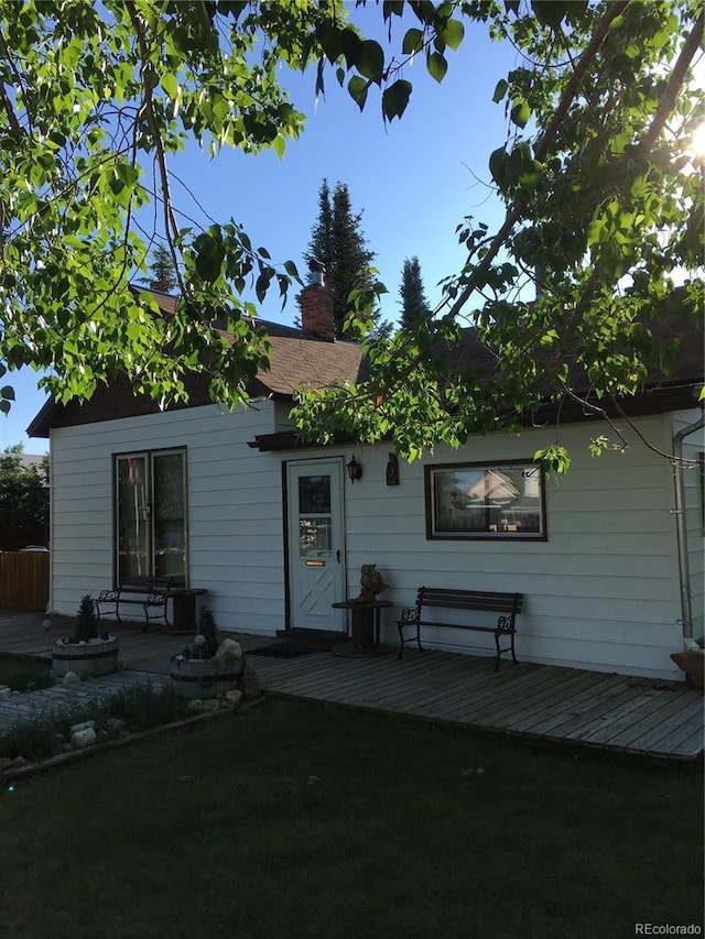 rear view of property featuring a wooden deck