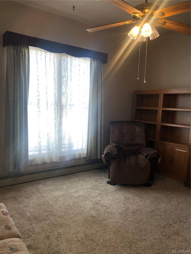 sitting room featuring ceiling fan, a baseboard radiator, and carpet