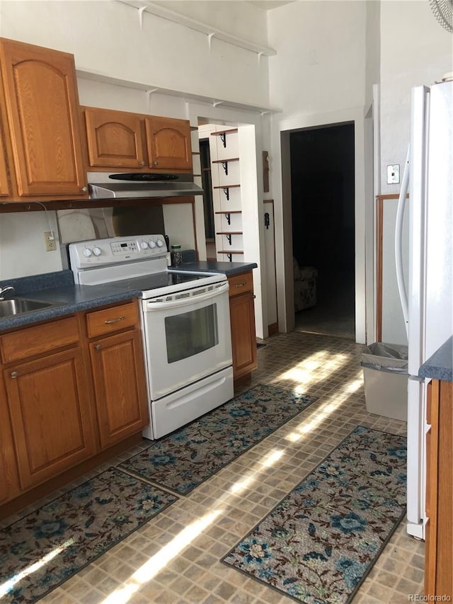 kitchen with white appliances and sink