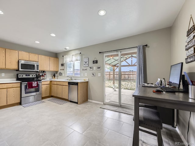 4935 E 100th Dr, Thornton, CO 80229 - kitchen with appliances with stainless steel finishes, light brown cabinetry, light countertops, an office area, and recessed lighting
