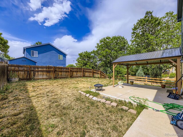 4935 E 100th Dr, Thornton, CO 80229 - fenced backyard featuring a gazebo, a patio, and a fire pit