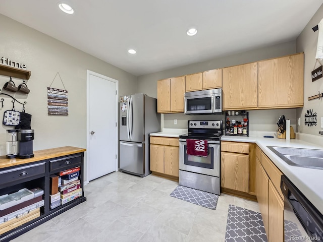 4935 E 100th Dr, Thornton, CO 80229 - kitchen with stainless steel appliances, light countertops, open shelves, light brown cabinets, and recessed lighting