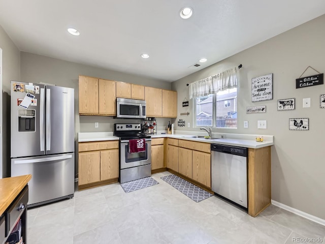 4935 E 100th Dr, Thornton, CO 80229 - kitchen featuring appliances with stainless steel finishes, light countertops, light brown cabinets, and recessed lighting