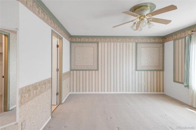 empty room featuring carpet flooring, ceiling fan, wallpapered walls, and visible vents