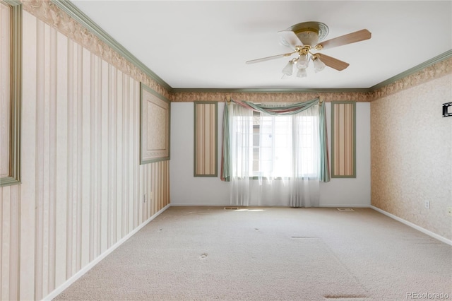 unfurnished room with baseboards, wallpapered walls, ceiling fan, light carpet, and crown molding