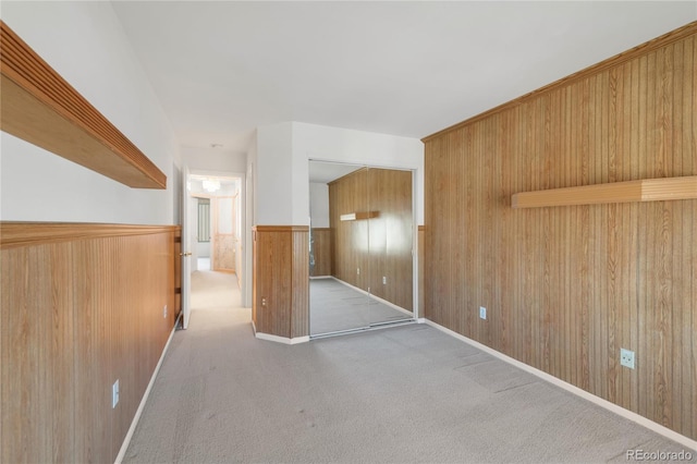 bonus room featuring wooden walls, a wainscoted wall, and carpet floors