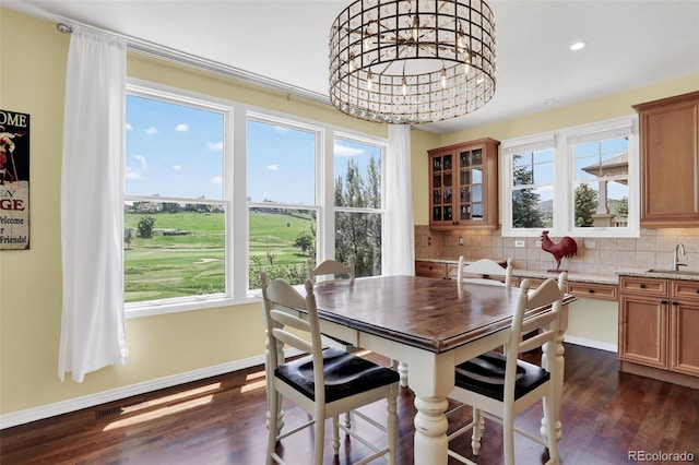 11208 W Ontario Ave, Littleton, CO 80127 - dining space featuring healthy amount of natural light, dark wood finished floors, recessed lighting, and a chandelier
