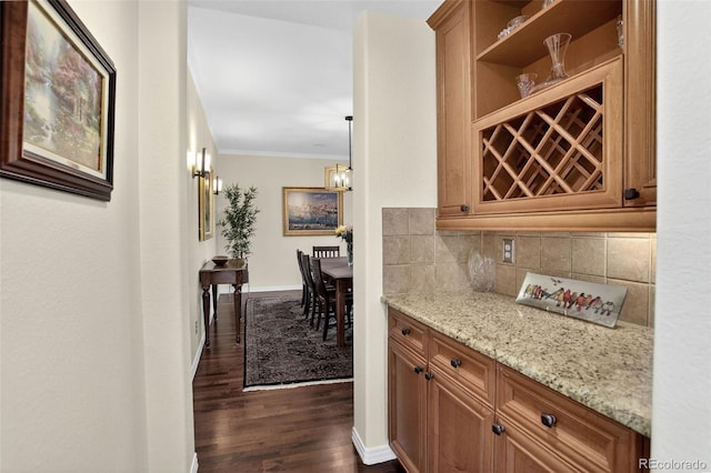 11208 W Ontario Ave, Littleton, CO 80127 - bar with ornamental molding, dark wood-style flooring, and tasteful backsplash