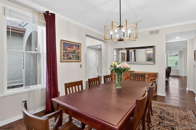 11208 W Ontario Ave, Littleton, CO 80127 - dining room featuring dark wood finished floors, crown molding, and a chandelier