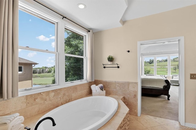 11208 W Ontario Ave, Littleton, CO 80127 - full bath featuring a garden tub, healthy amount of natural light, tile patterned flooring, and ensuite bathroom