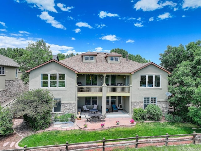11208 W Ontario Ave, Littleton, CO 80127 - back of property with stucco siding, stone siding, a balcony, and a patio area
