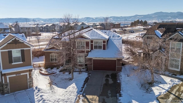 view of front facade featuring a mountain view and a garage