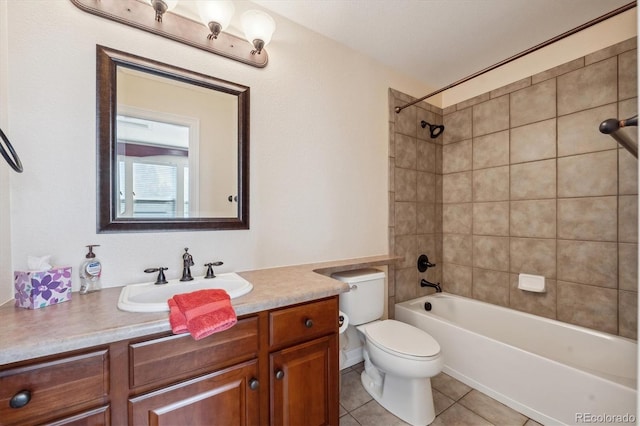 full bathroom featuring tiled shower / bath, toilet, tile patterned floors, and vanity