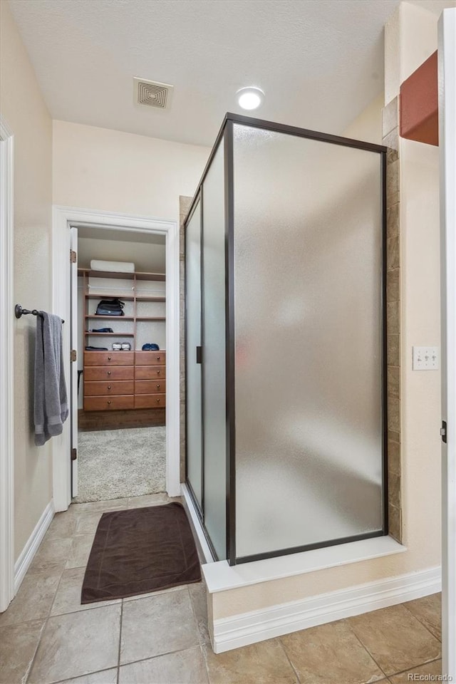 bathroom featuring a shower with shower door